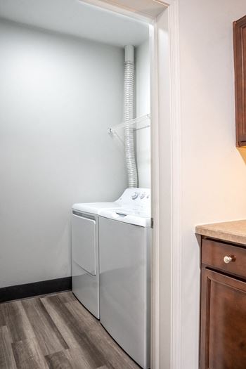 an empty laundry room with a washer and dryer